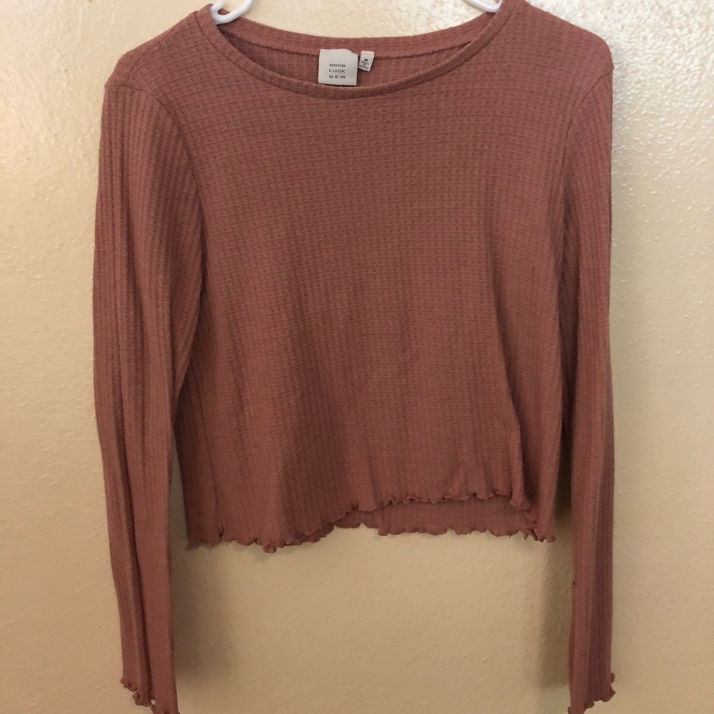 Long sleeve, somewhat cropped shirt.